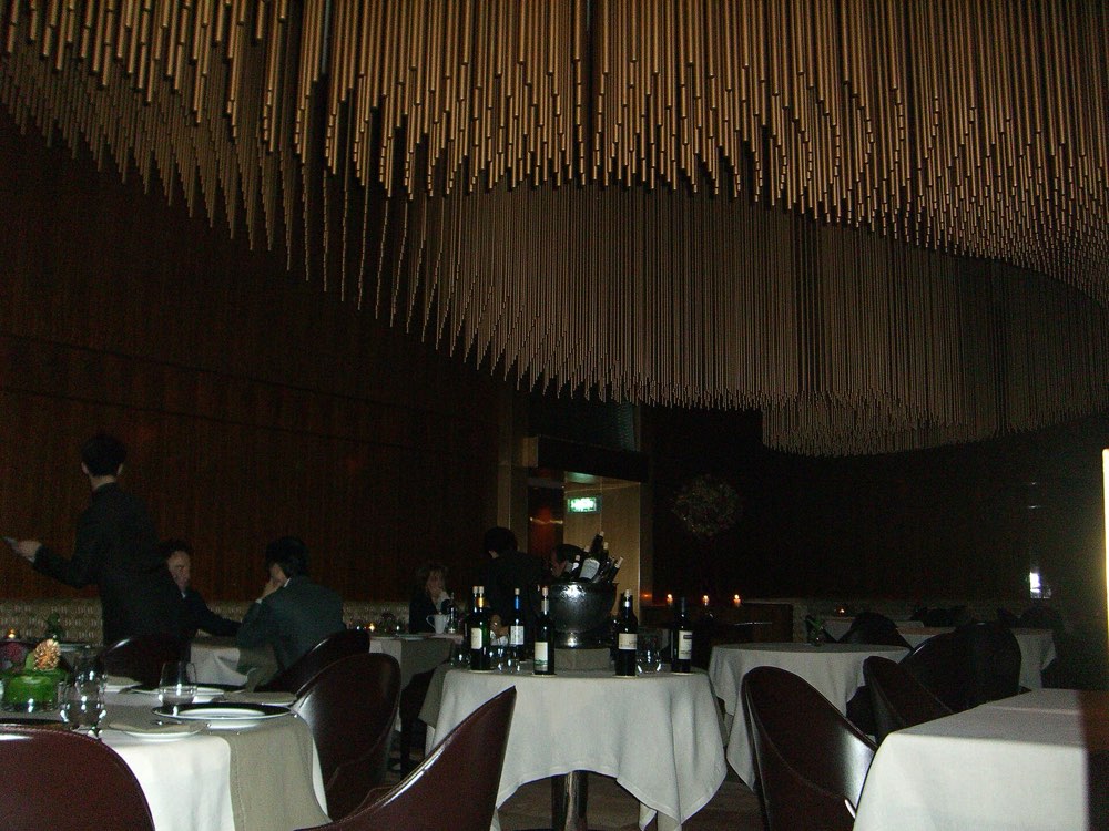 The dining room of Amber, Hong Kong, under its hanging rod ceiling