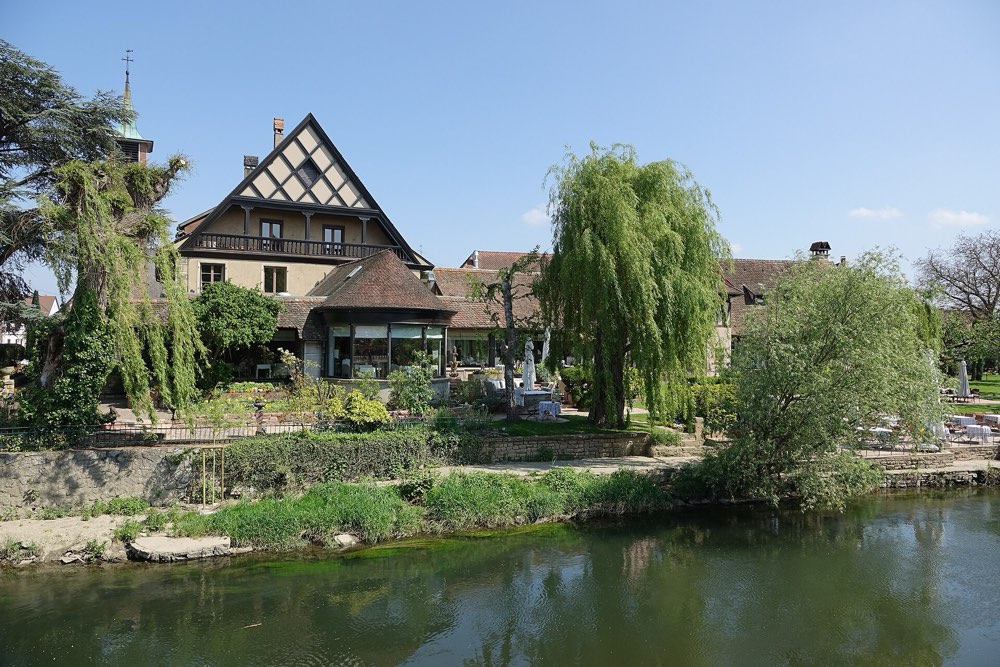 Auberge de l'Ill beside the river Ill in Illhaeusern, Alsace, with willows in the garden