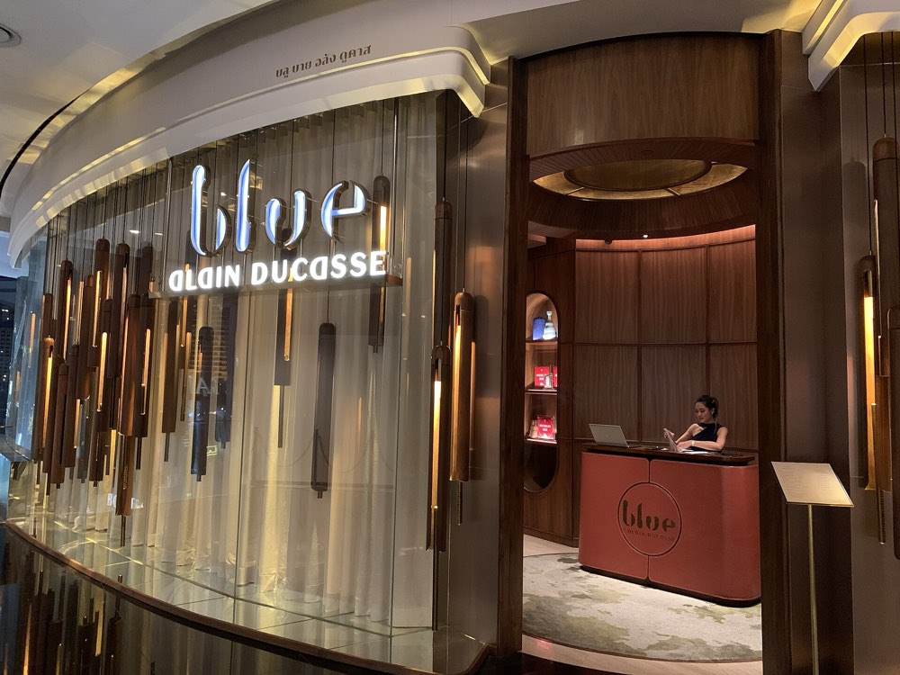 The entrance and reception desk of Blue by Alain Ducasse at Iconsiam, Bangkok