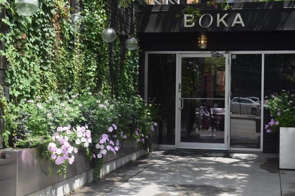 The entrance of Boka in Lincoln Park, Chicago, beside an ivy-covered wall