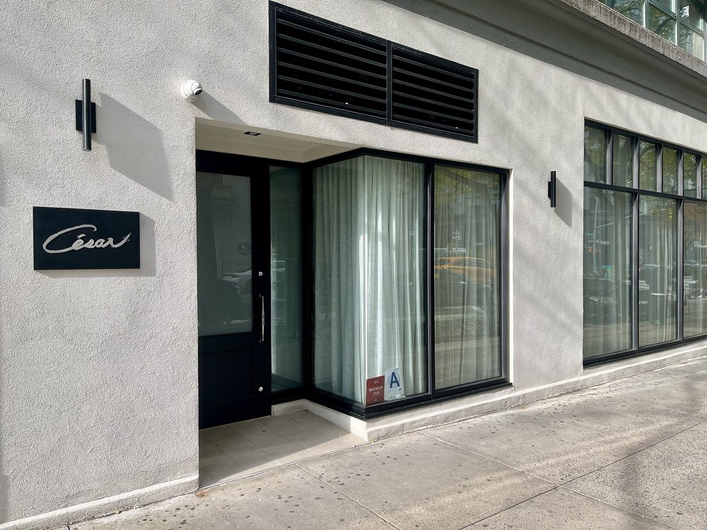 The entrance of César with its name sign at 333 Hudson Street, New York