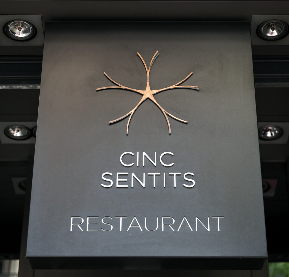 The Cinc Sentits restaurant sign above the entrance, Barcelona