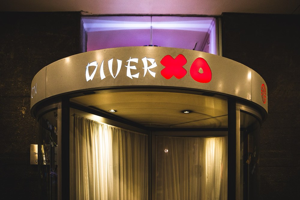 The revolving-door entrance of DiverXO under its lit sign, Madrid