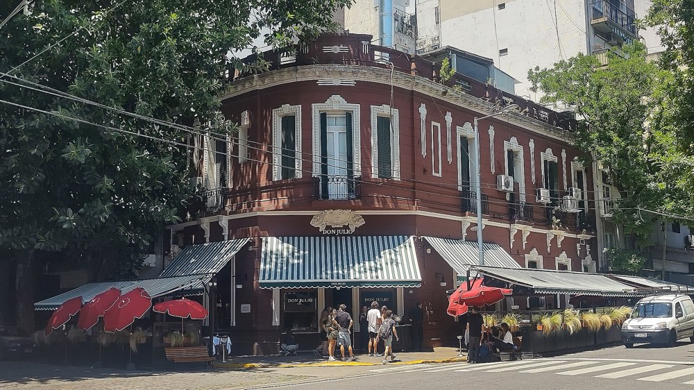 The corner building of Parrilla Don Julio in Palermo, Buenos Aires, with striped awnings