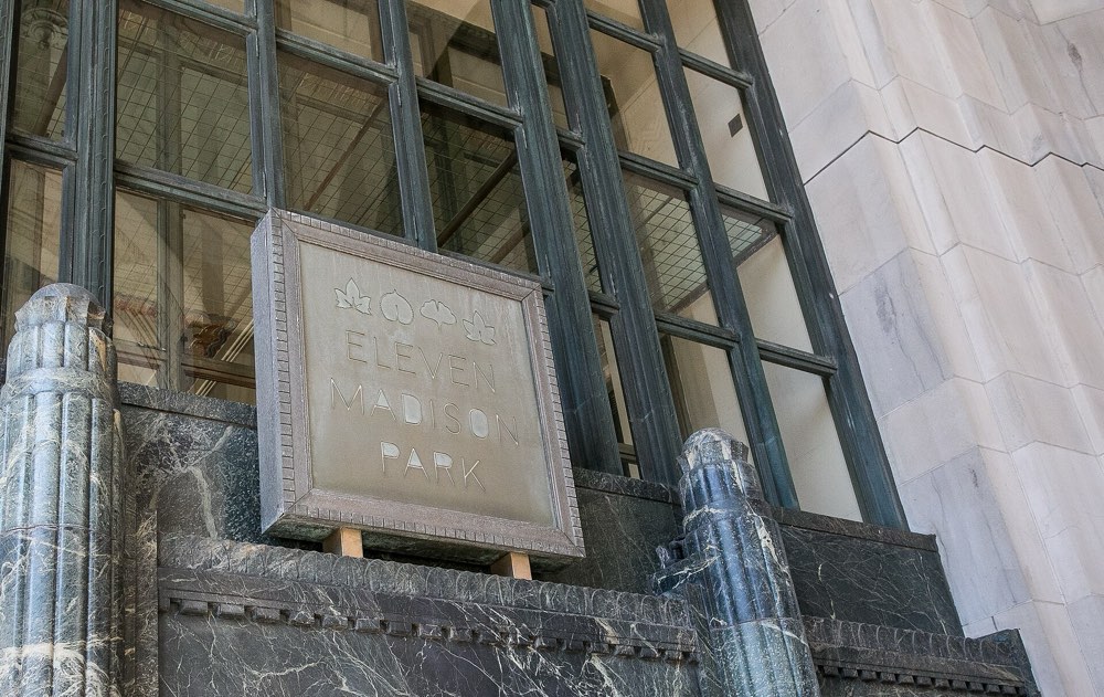 The Eleven Madison Park sign in the windows of its Art Deco building, New York