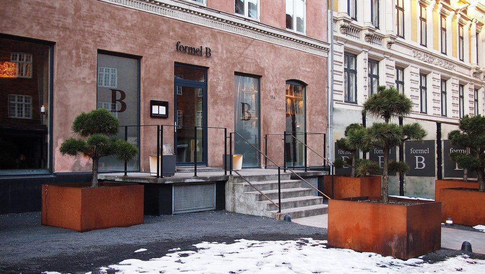 The front of formel B in Frederiksberg, Copenhagen, with planters by the steps