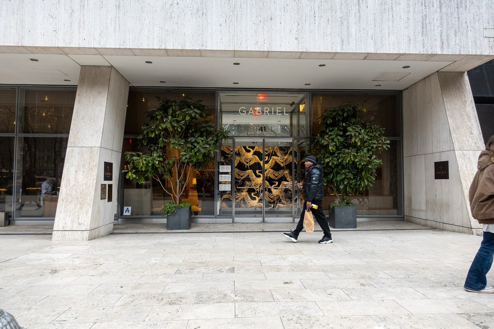 The entrance of Gabriel Kreuther in the W. R. Grace Building, New York, with its name on the glass
