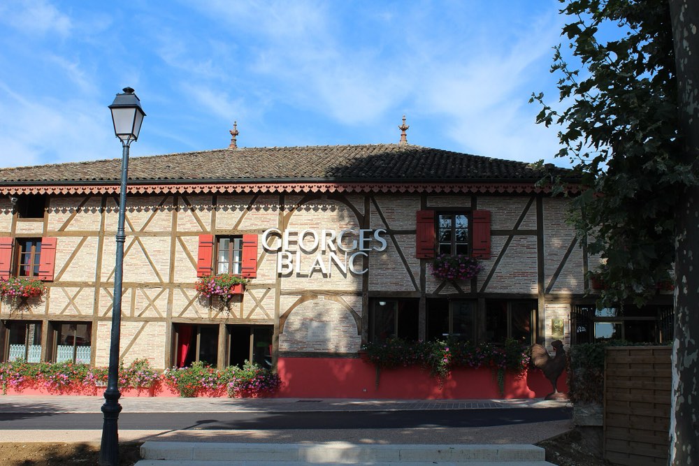 The half-timbered Georges Blanc building in Vonnas, with its name on the facade