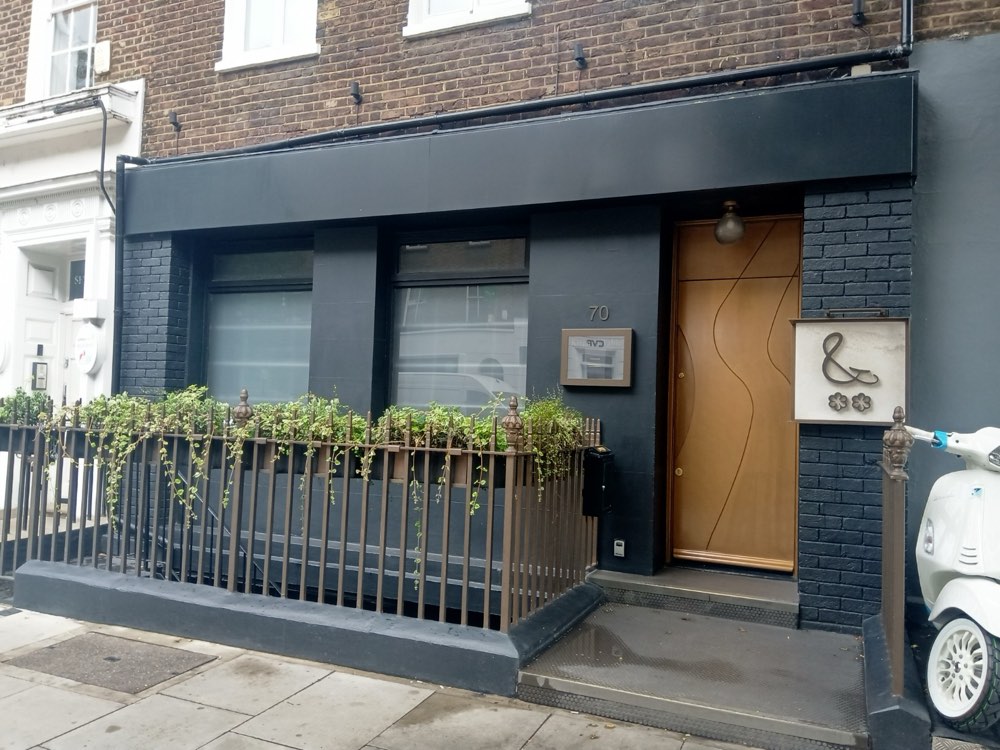 The dark shopfront and wooden door of Kitchen Table on Charlotte Street, Fitzrovia, London
