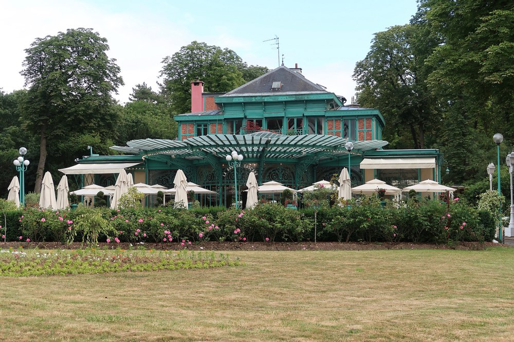 The green pavilion of La Grande Cascade in the Bois de Boulogne, Paris, with its terrace parasols
