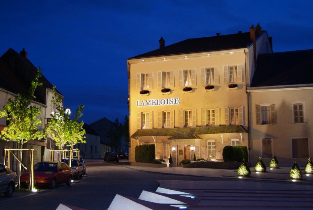 The Lameloise building in Chagny at night, with its name above the windows
