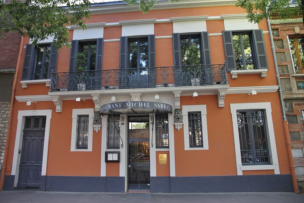 The orange facade of Restaurant Michel Sarran on Boulevard Armand Duportal, Toulouse