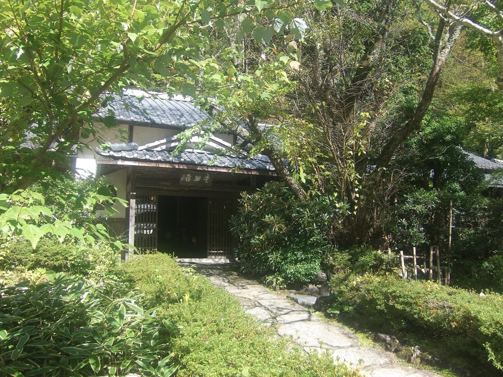 The tiled-roof entrance of Miyamaso among trees in Hanase, north of Kyoto