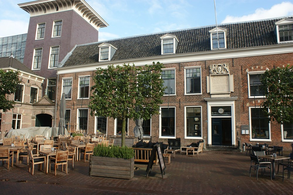 The old brick building on Klokhuisplein, Haarlem, home of ML, with a terrace in front