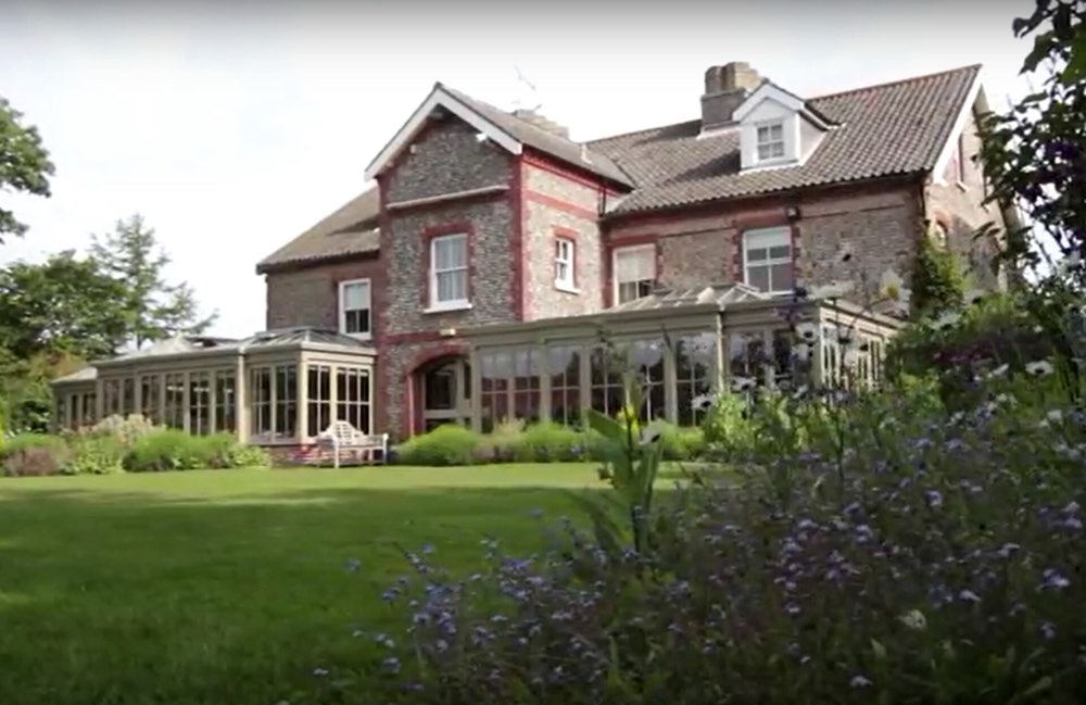 Morston Hall and its conservatory seen across the lawn, Norfolk