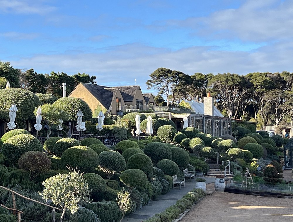 Mudbrick restaurant behind its clipped gardens on Waiheke Island