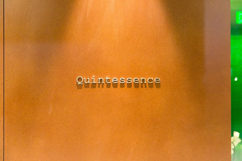 The Quintessence name sign on a wooden wall outside the restaurant, Tokyo