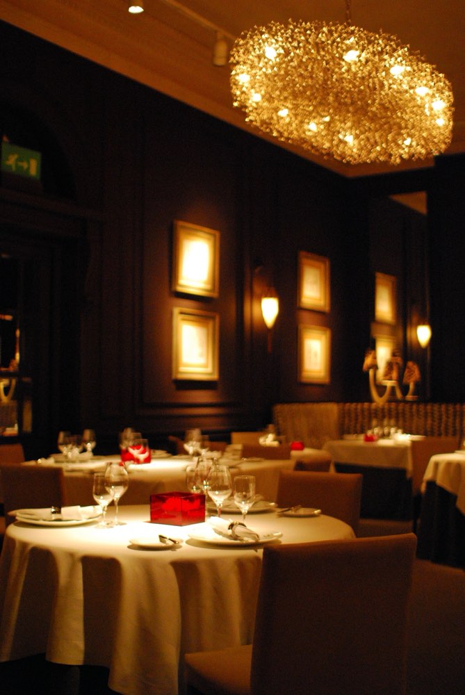 The dark-panelled dining room of Restaurant Andrew Fairlie at Gleneagles, with laid tables