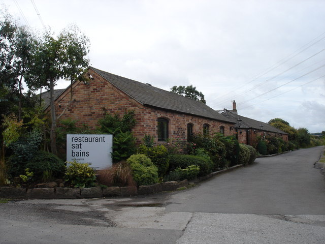 The brick buildings of Restaurant Sat Bains in Nottingham, with its sign by the lane
