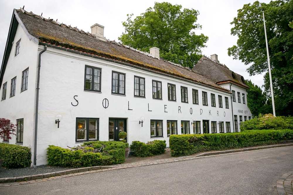 The thatched white inn of Søllerød Kro with its name on the wall, Holte