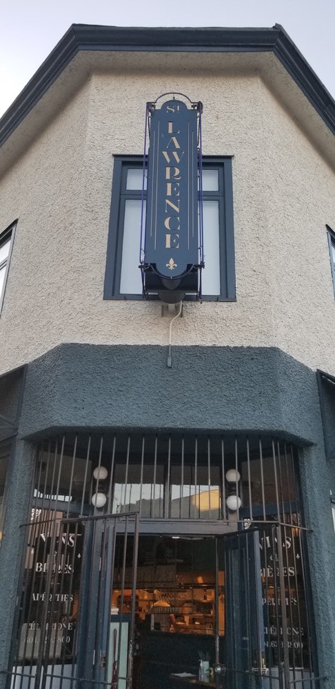 The corner front of St. Lawrence restaurant in Vancouver, with its hanging sign