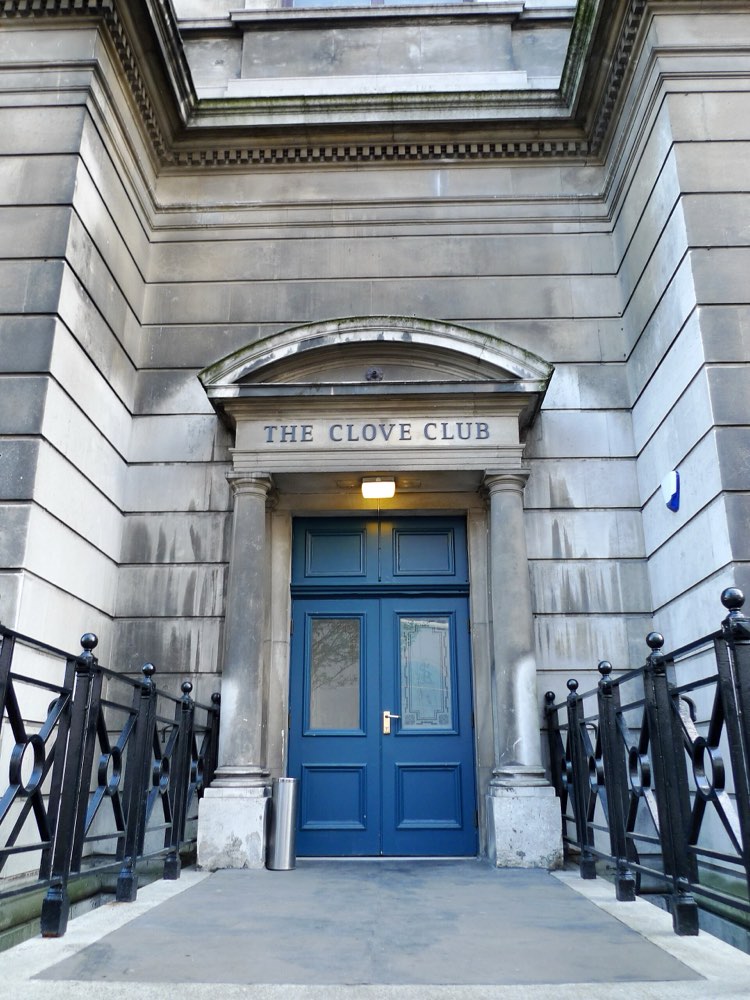 The blue door of The Clove Club under its name in Shoreditch Town Hall, London